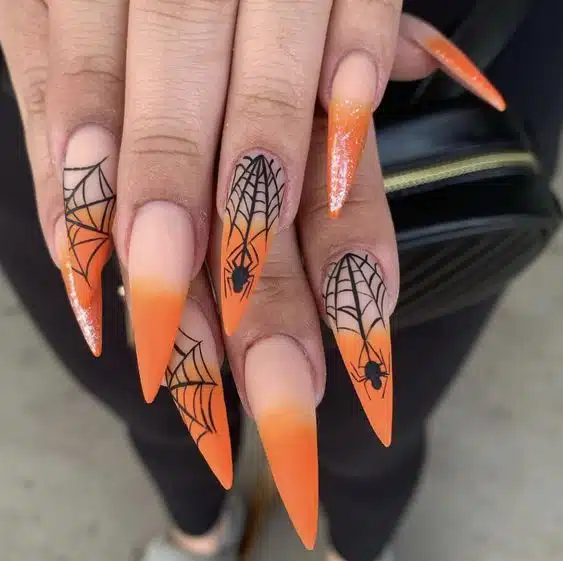 Orange stiletto spider web nails