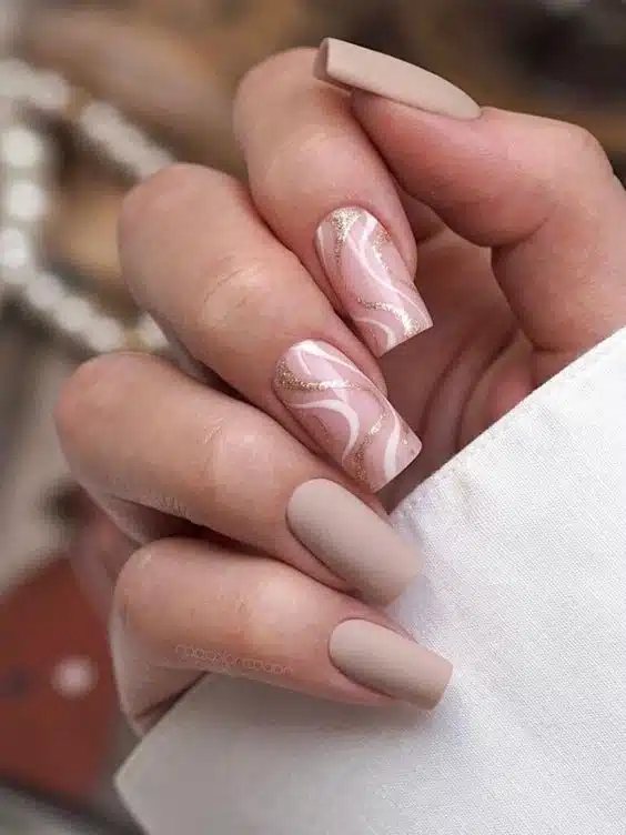 nude gold and white swirl nails