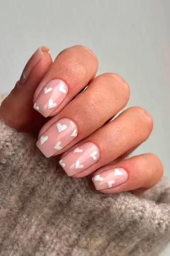 Nude and white hearts nails